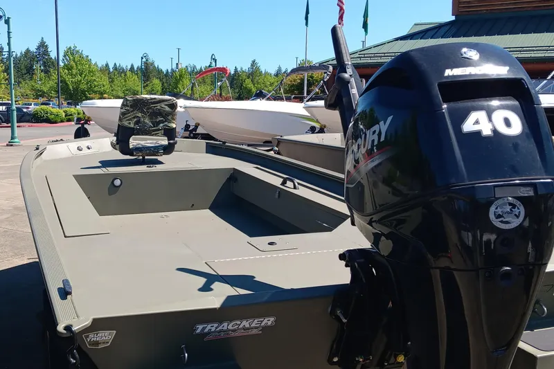 Slide: The Image of 2025 Tracker Grizzly 1654 T Sportsman boat with Mercury 40 engine in outdoor setting. - 3
