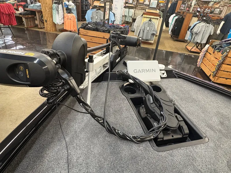 Slide: The Image of 2025 Tracker Savage 215 boat with Garmin and Minn Kota equipment on display. - 2