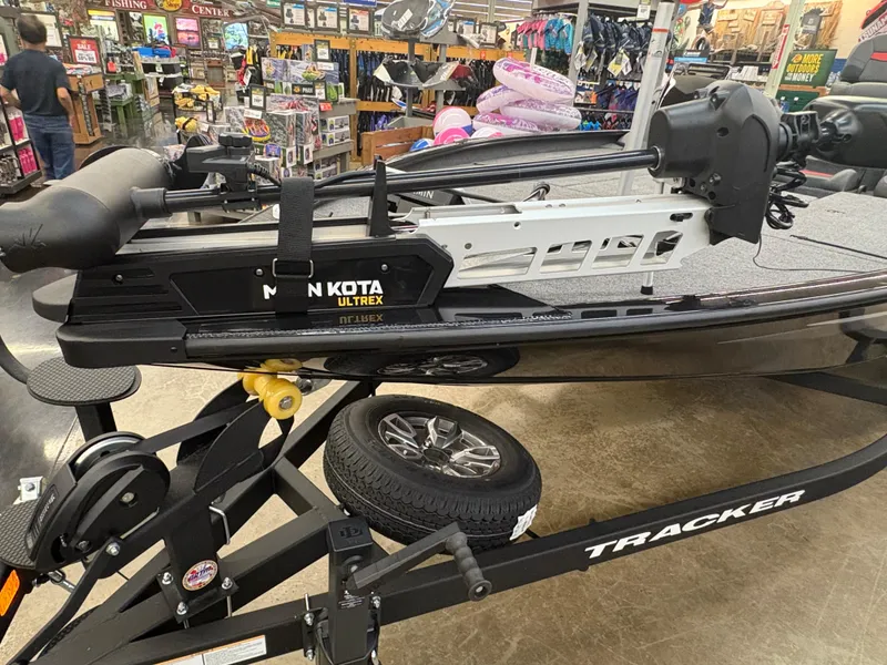 Slide: The Image of 2025 Tracker Savage 215 boat with Minn Kota Ultrex motor in a store display. - 3