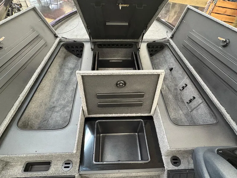 Slide: The Image of 2025 Tracker Savage 215 boat storage compartments, open and spacious interior view. - 6