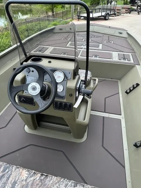 Slide: The Image of 2025 Tracker Grizzly 2072 CC boat interior with steering console and spacious deck. - 4