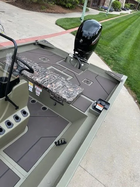 Slide: The Image of 2025 Tracker Grizzly 2072 CC boat with camo seating and powerful outboard motor. - 6