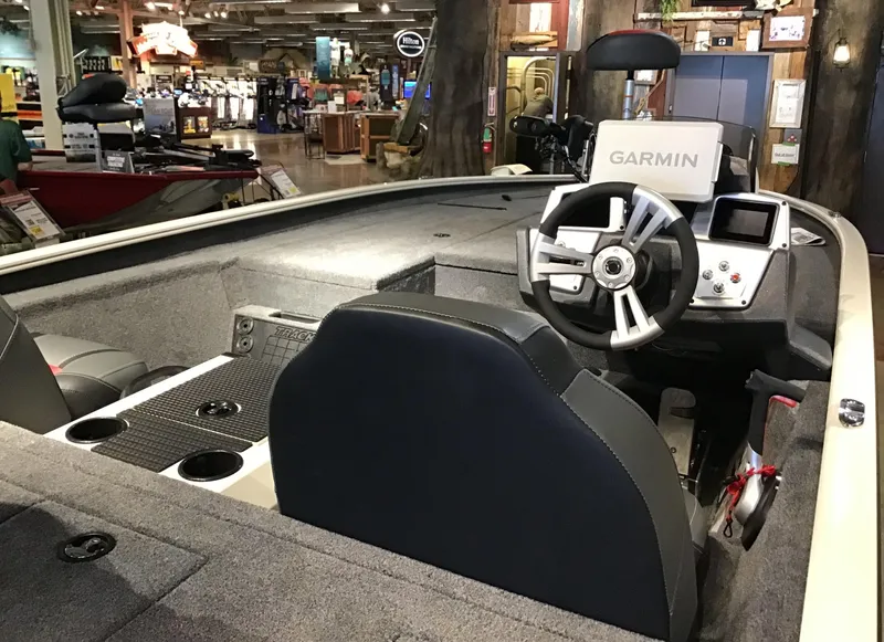 Slide: The Image of 2025 Tracker Savage 215 boat interior with Garmin navigation system and modern steering wheel. - 2