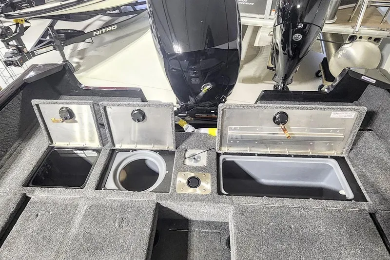 Slide: The Image of 2025 Tracker Pro Guide V-175 Combo boat interior with storage compartments and motor. - 10