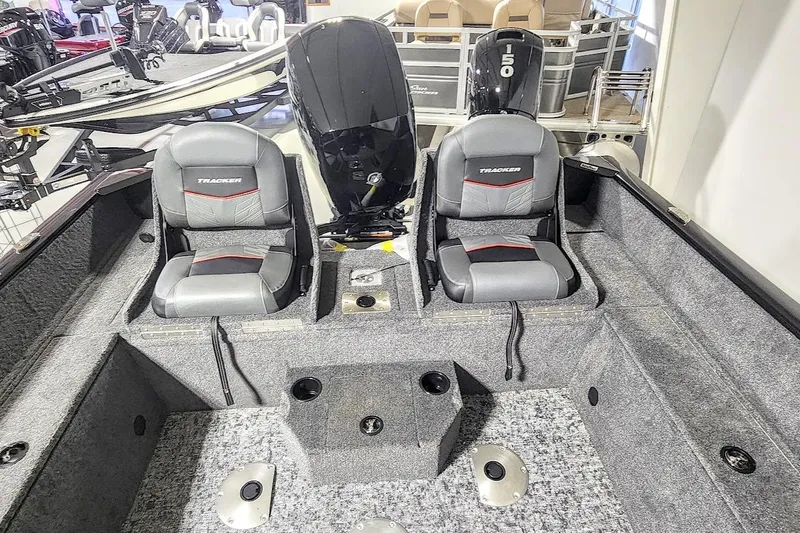 Slide: The Image of 2025 Tracker Pro Guide V-175 Combo boat interior with dual seats and motor. - 13