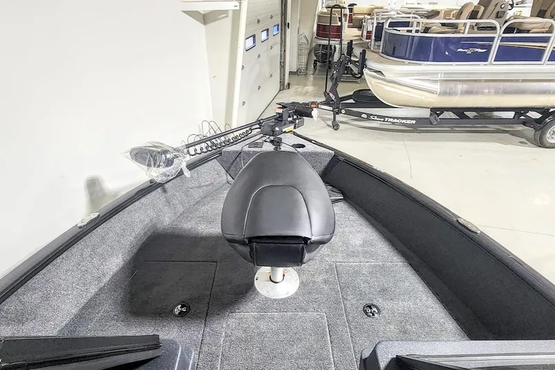 Slide: The Image of 2025 Tracker Pro Guide V-175 Combo boat interior with seating and trolling motor. - 3