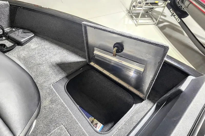 Slide: The Image of 2025 Tracker Pro Guide V-175 Combo boat storage compartment with open lid. - 5