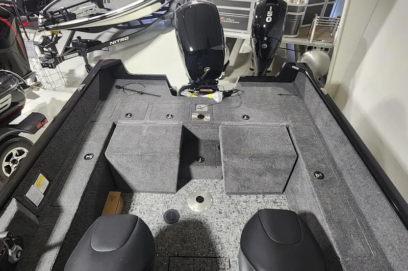 Slide: The Image of 2025 Tracker Pro Guide V-175 Combo boat interior with seating and motor. - 9