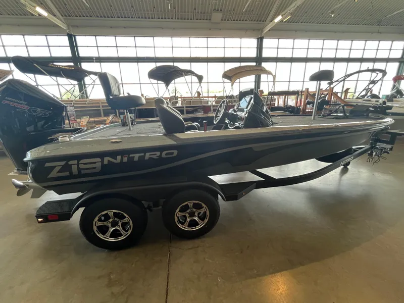 Slide: The Image of 2025 Nitro Z19 Pro boat displayed indoors, featuring sleek design and dual-axle trailer. - 1