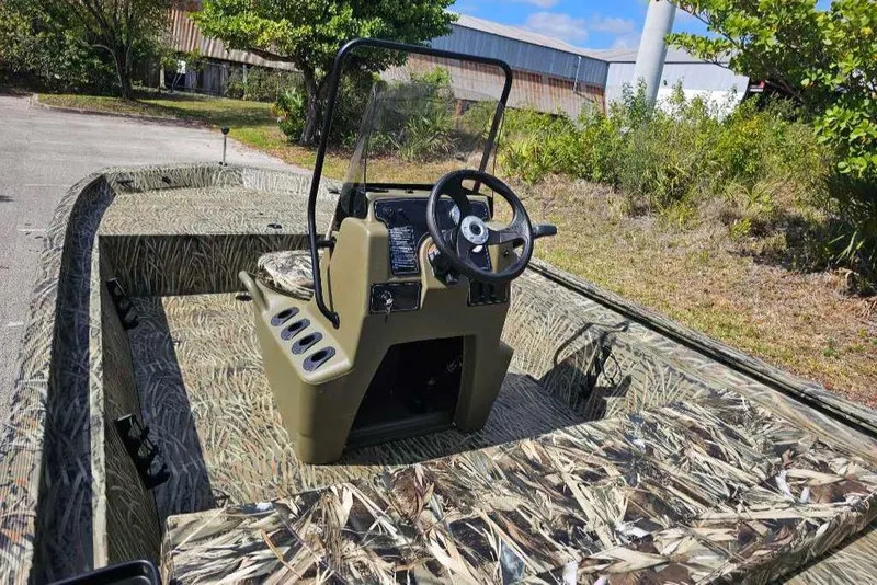 Slide: The Image of 2025 Tracker Grizzly 1860 CC boat with camouflage design and central steering console. - 6