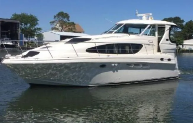 Slide: The Image of 2003 Sea Ray 390 Motor Yacht on calm water, showcasing sleek design and luxury features. - 0