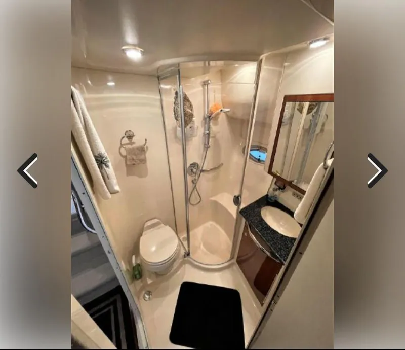 Slide: The Image of Luxurious bathroom in 2003 Sea Ray 390 Motor Yacht with shower, sink, and toilet. - 13