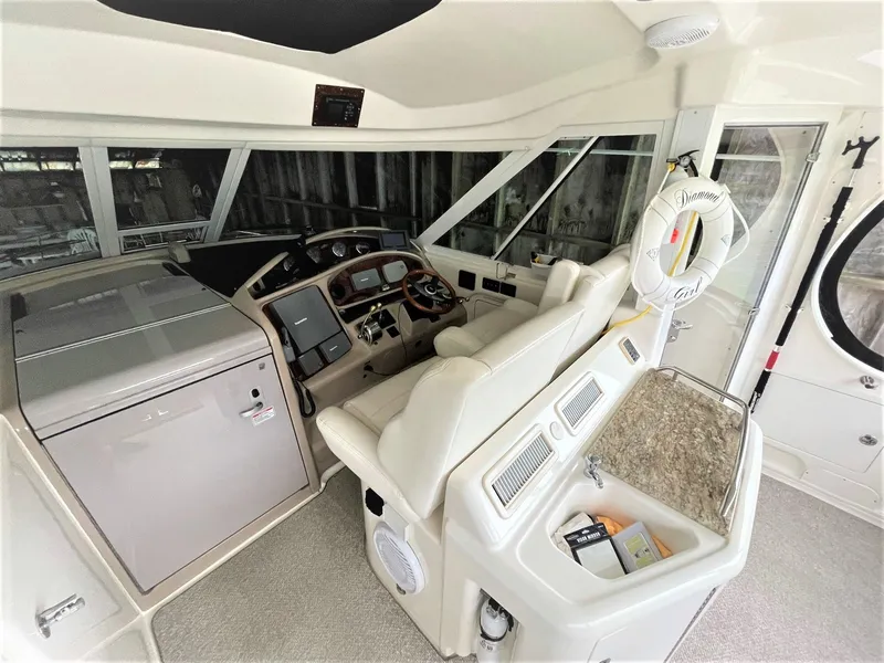 Slide: The Image of 2003 Sea Ray 390 Motor Yacht helm with modern controls and comfortable seating. - 27
