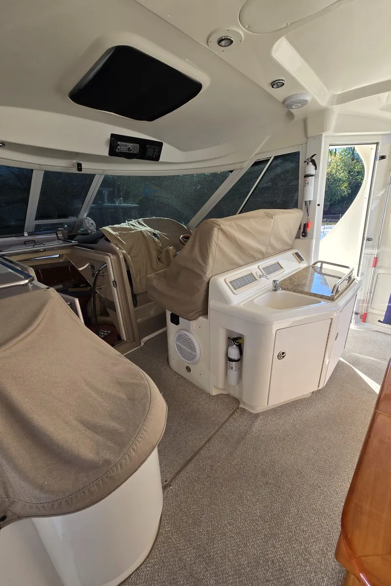 Slide: The Image of 2003 Sea Ray 390 Motor Yacht interior with covered helm and seating area. - 36