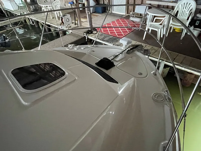 Slide: The Image of 2003 Sea Ray 390 Motor Yacht docked, showing deck and railing details. - 43