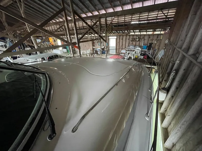 Slide: The Image of 2003 Sea Ray 390 Motor Yacht in a wooden boathouse, showcasing sleek design. - 44