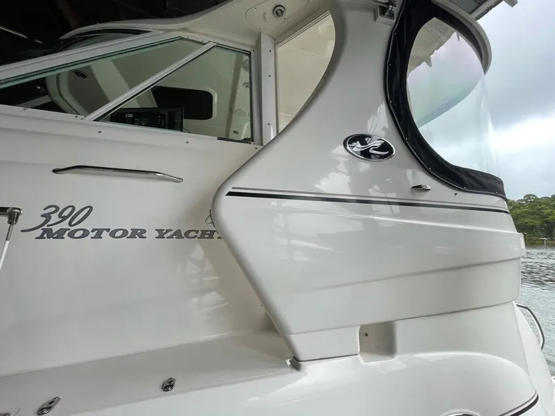 Slide: The Image of 2003 Sea Ray 390 Motor Yacht, sleek white exterior, docked by the water. - 47