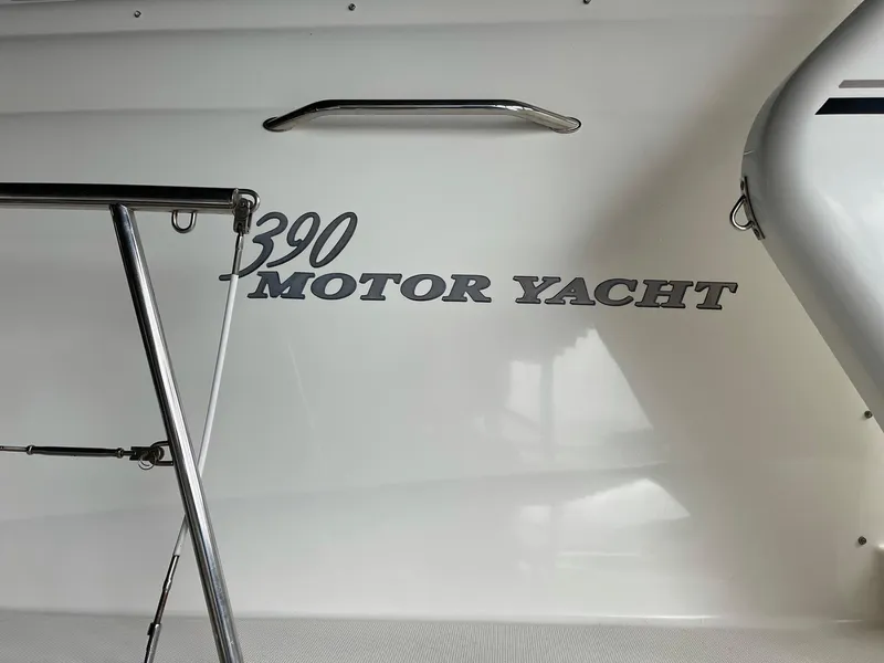 Slide: The Image of 2003 Sea Ray 390 Motor Yacht side view with railing and logo. - 48