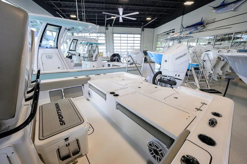 Slide: The Image of 2025 Sportsman Masters 267 Bay Boat interior in showroom, featuring modern design and equipment. - 12