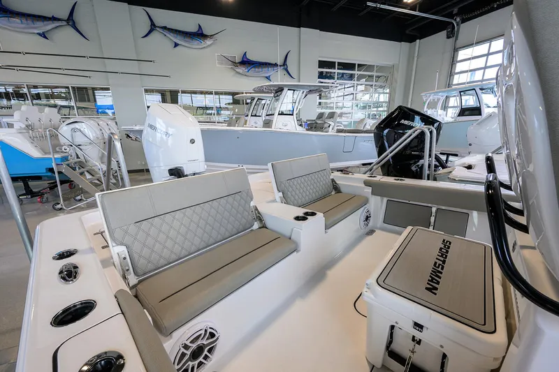 Slide: The Image of 2025 Sportsman Masters 267 Bay Boat interior with seating and modern design in showroom. - 13