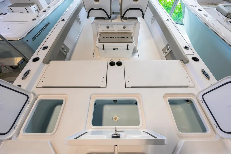Slide: The Image of 2025 Sportsman Masters 267 Bay Boat interior with storage compartments and seating. - 17