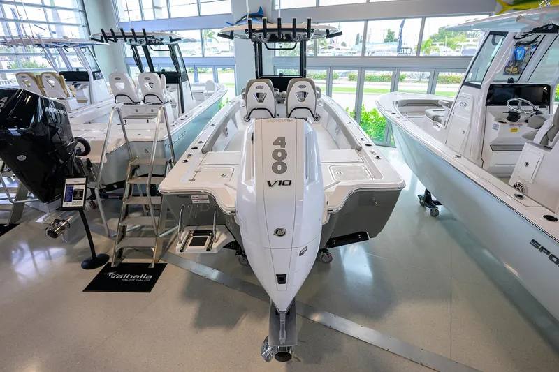 Slide: The Image of 2025 Sportsman Masters 267 Bay Boat with 400 V10 engine displayed indoors. - 21