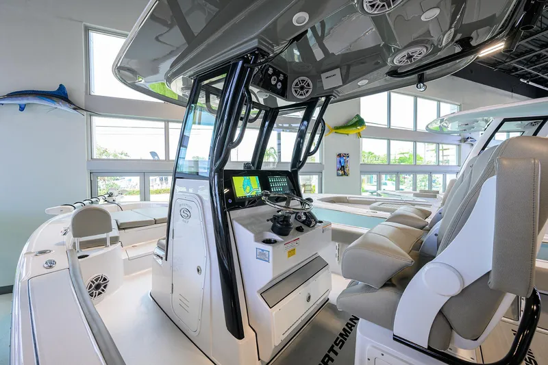 Slide: The Image of 2025 Sportsman Masters 267 Bay Boat interior with modern console and seating. - 24