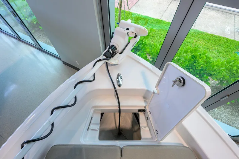 Slide: The Image of 2025 Sportsman Masters 267 Bay Boat interior with trolling motor and storage compartment. - 3