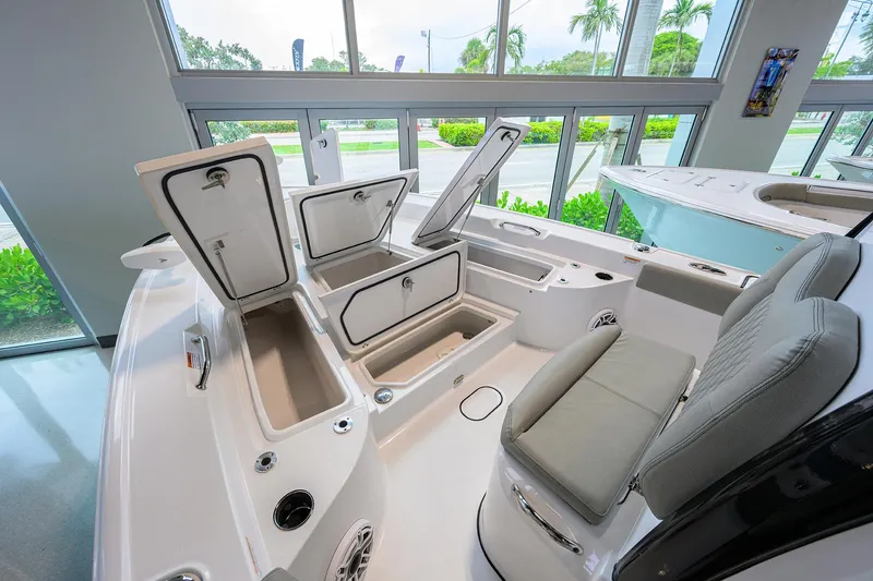 Slide: The Image of 2025 Sportsman Masters 267 Bay Boat interior with open storage compartments and seating. - 8
