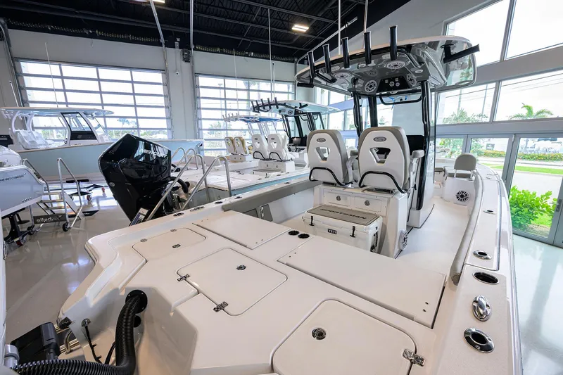 Slide: The Image of 2025 Sportsman Masters 267 Bay Boat in showroom, featuring dual seats and modern console. - 9