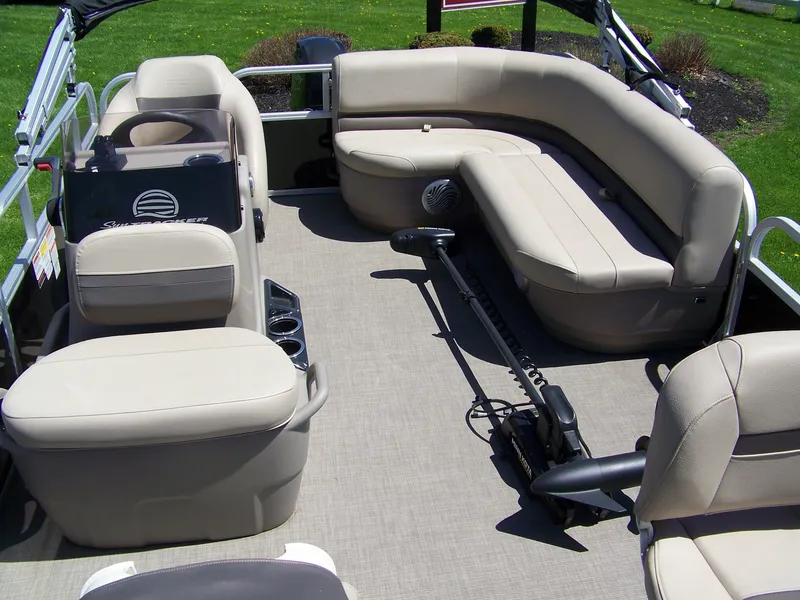 Slide: The Image of 2021 Sun Tracker Bass Buggy 16 XL pontoon boat interior with beige seating and spacious layout. - 3