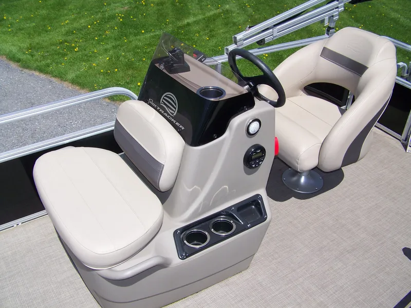 Slide: The Image of 2021 Sun Tracker Bass Buggy 16 XL boat interior with beige seating and steering console. - 4