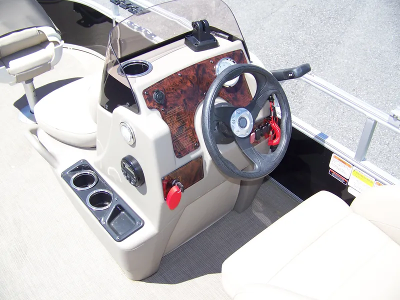 Slide: The Image of 2021 Sun Tracker Bass Buggy 16 XL boat console with steering wheel and cup holders. - 5