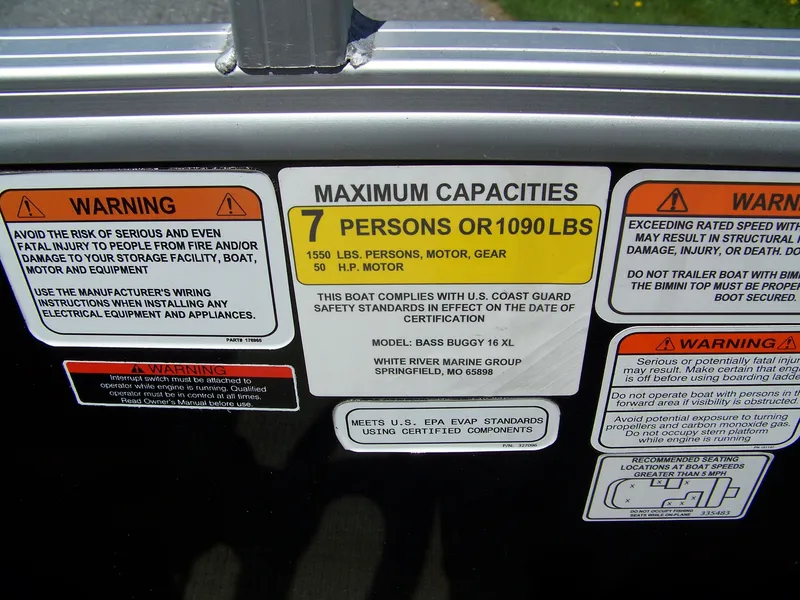 Slide: The Image of 2021 Sun Tracker Bass Buggy 16 XL capacity warning labels, maximum 7 persons or 1090 lbs. - 7
