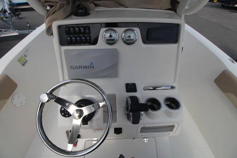 Slide: The Image of 2017 Sailfish 236 CC boat dashboard with Garmin navigation system and steering wheel. - 11