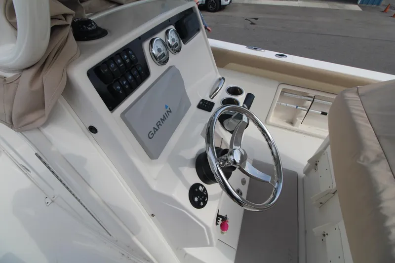 Slide: The Image of 2017 Sailfish 236 CC boat console with Garmin navigation and steering wheel. - 12