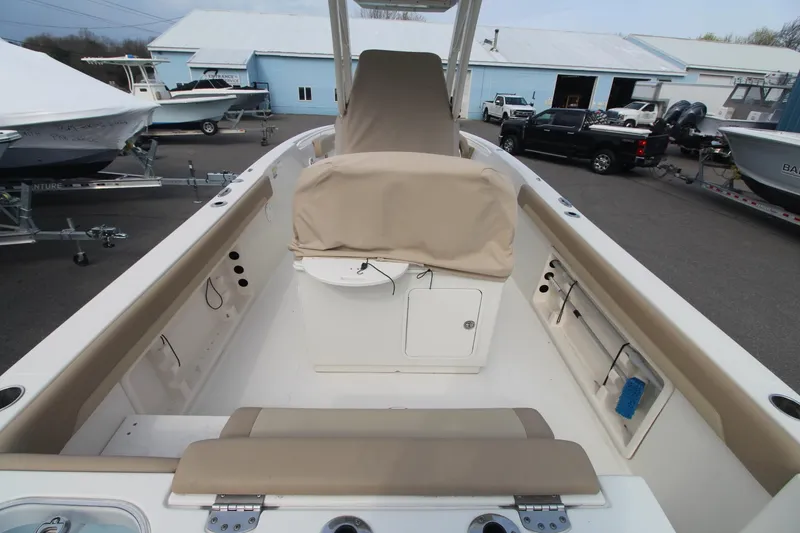 Slide: The Image of 2017 Sailfish 236 CC boat interior with beige seating and storage compartments. - 5