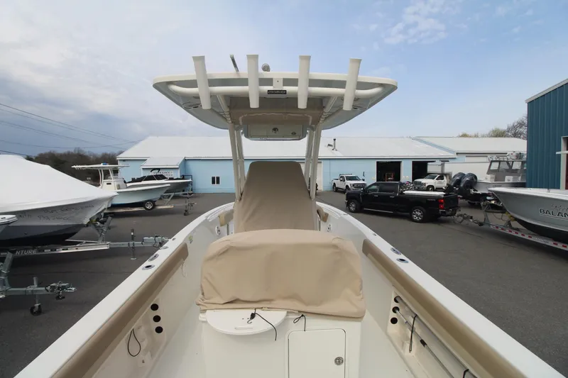 Slide: The Image of 2017 Sailfish 236 CC boat in a marina, showcasing its deck and T-top. - 6