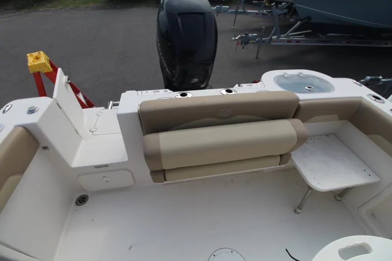 Slide: The Image of 2017 Sailfish 236 CC boat interior with seating and table, featuring a clean, spacious design. - 7