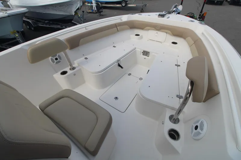 Slide: The Image of 2017 Sailfish 236 CC boat interior with beige seating and storage compartments. - 8