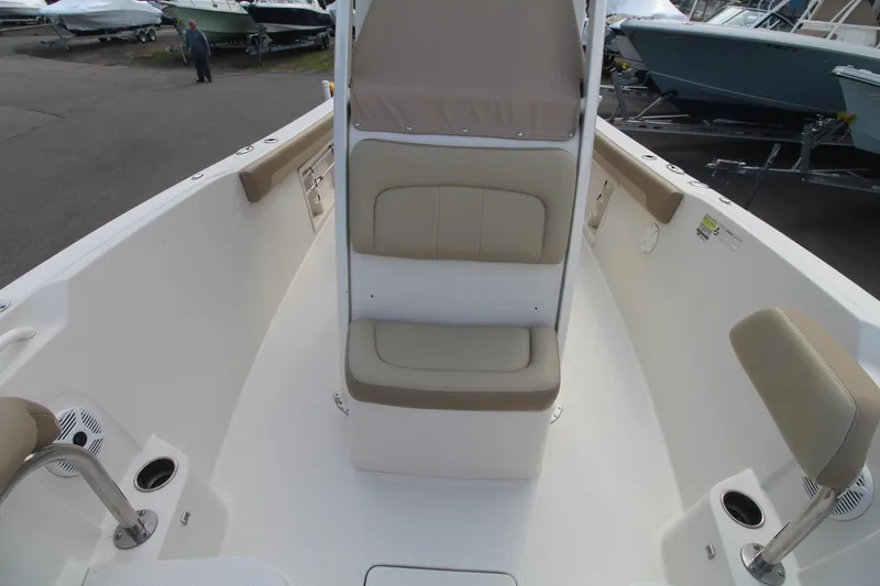 Slide: The Image of 2017 Sailfish 236 CC boat interior with beige seating and cup holders. - 9