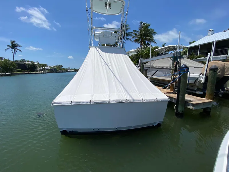Slide: The Image of 1995 L&H 33 boat docked in sunny marina with palm trees. - 10