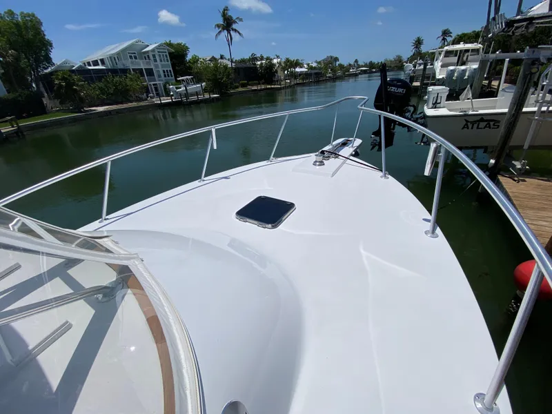Slide: The Image of Bow view of 1995 L&H 33 boat docked in a scenic canal. - 13