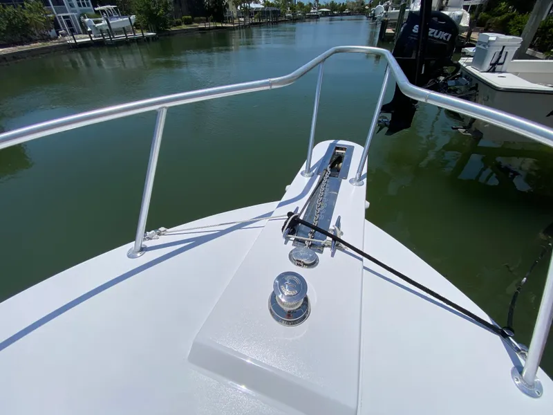 Slide: The Image of Bow view of 1995 L&H 33 boat on calm waterway. - 15