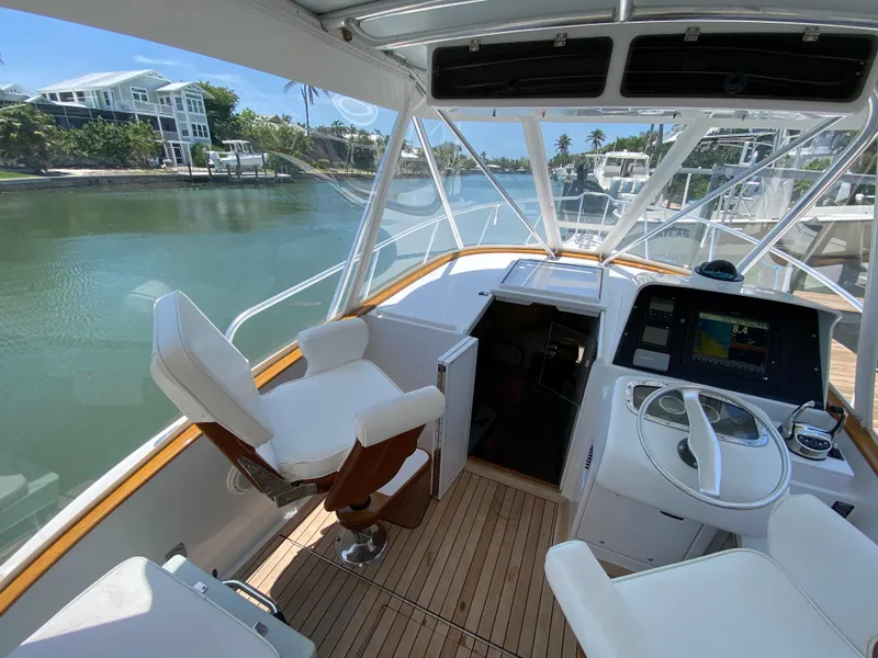 Slide: The Image of Helm of 1995 L&H 33 boat with modern controls and waterfront view. - 17