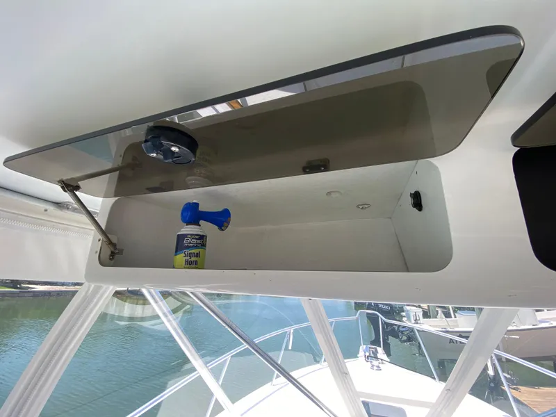 Slide: The Image of Open storage compartment on 1995 L&H 33 boat with signal horn inside. - 21
