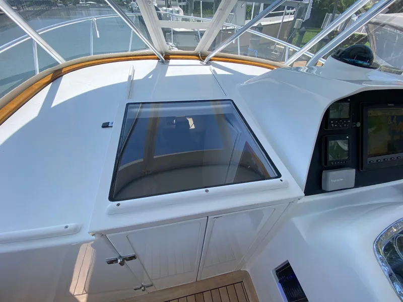 Slide: The Image of 1995 L&H 33 boat cockpit with glass hatch and navigation controls. - 25