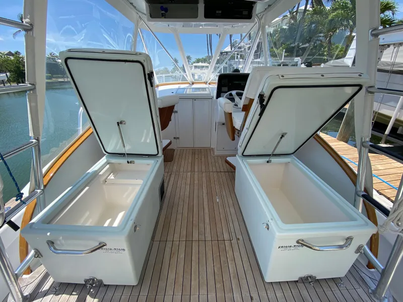 Slide: The Image of Open storage compartments on a 1995 L&H 33 boat with wooden deck. - 26