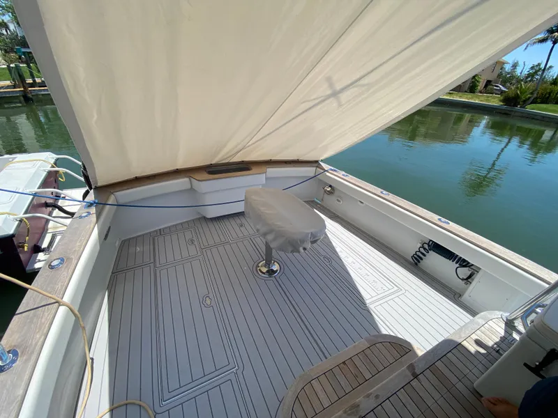 Slide: The Image of 1995 L&H 33 boat deck with seating, covered area, and water view. - 28