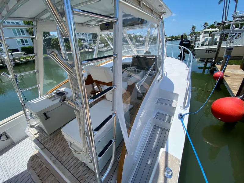 Slide: The Image of 1995 L&H 33 boat docked, featuring sleek design and modern amenities. - 29